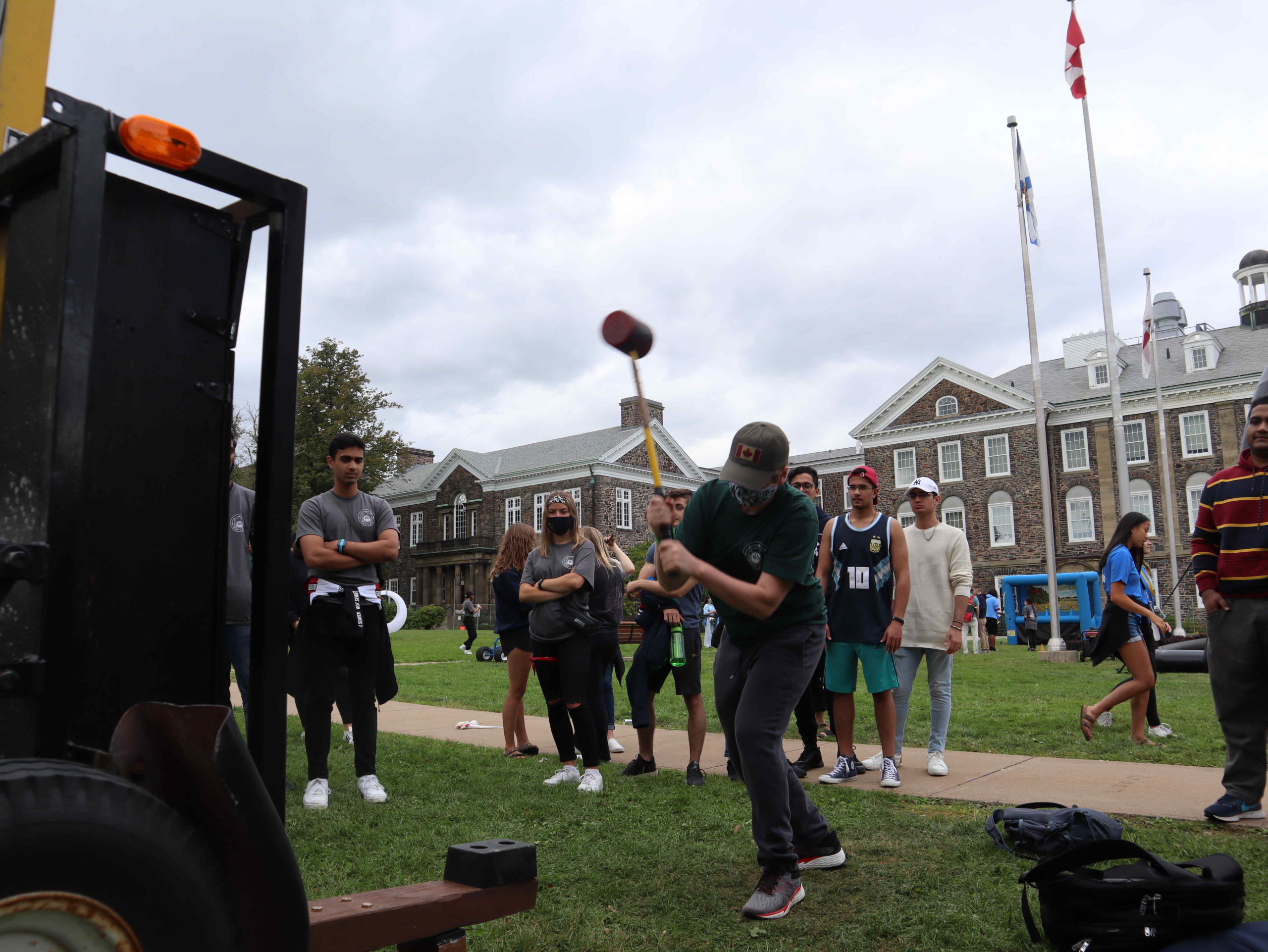 students cheer on someone playing a carnival game at Dal O-Week